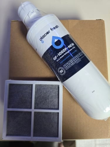 Customer's new refrigerator water filter and air filter from the bundle resting on a cardboard box.