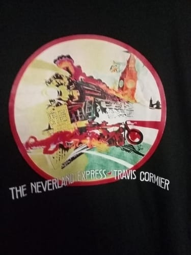 Close-up of a customer's black unisex t-shirt with a circular graphic for 'The Neverland Express - Travis Cormier'.