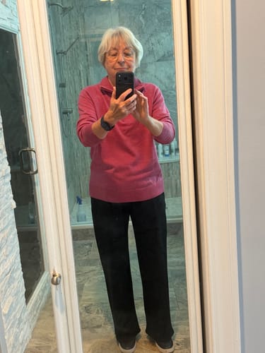 Reviewer wearing the black Brynn Petite Pants, showing the relaxed, wide-leg fit in a full-length view.