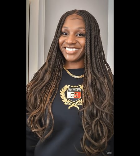 Customer smiling while wearing the Outre Glueless Pre-Braided wig with long, curly ends.