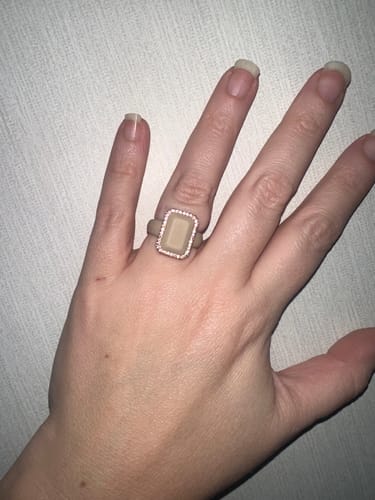 Customer's hand showing the top of the beige Emerald Silicone Ring with its sparkling CZ stone frame.