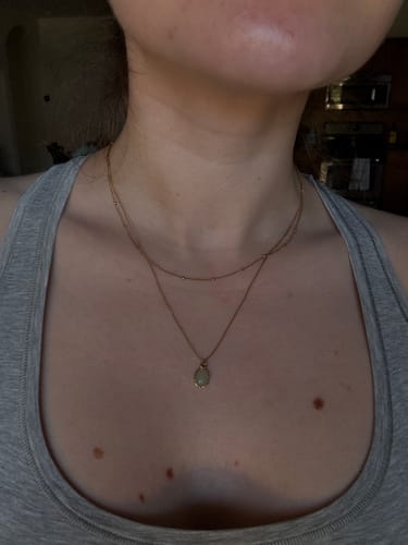 Customer showing the dainty size of the Green Aventurine Pendant Necklace against their chest.