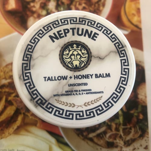 Reviewer's close-up of the white Neptune Tallow & Honey Balm jar, highlighting the decorative lid.