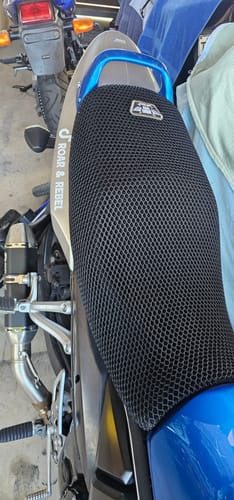 Customer's black mesh Wind Rider Seat Cover installed on the seat of their Suzuki motorcycle.