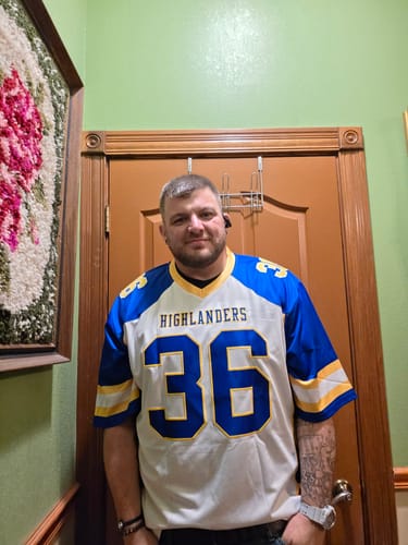 Customer wearing a custom 'Highlanders' football jersey in white and royal-gold with the number 36.