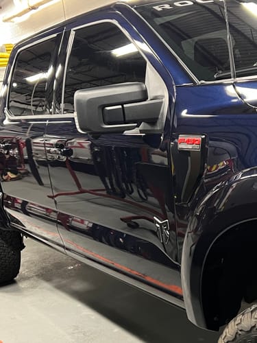 Reviewer's dark blue truck with a reflective shine after using the BLACKLINEĀ® WASH KIT.