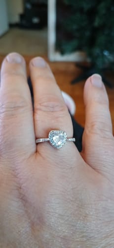 Customer's hand wearing the Forever In My Heart Urn Ring, which has a shiny, heart-shaped stone.