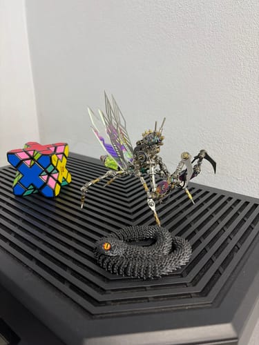 Customer's assembled Emerald Mantis model with iridescent wings displayed on a black PC case.