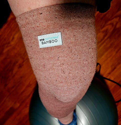Close-up of a customer's knee wearing the brown, textured Premium Bamboo Knee Sleeve.