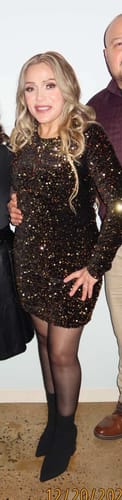 Reviewer showing the bodycon fit of the black Éloria Velvet Sequin Long Sleeve Mini Dress.