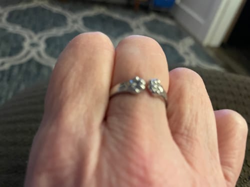 Close-up of a reviewer wearing the silver Paw Hug Ring on their finger.