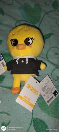 Customer's yellow SKZOO BbokAri plush wearing a black hoodie with its official tags attached.