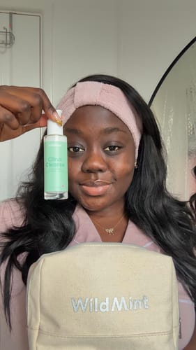 Reviewer holding a mini product with the travel bag from the Mini 5-Step Kit.