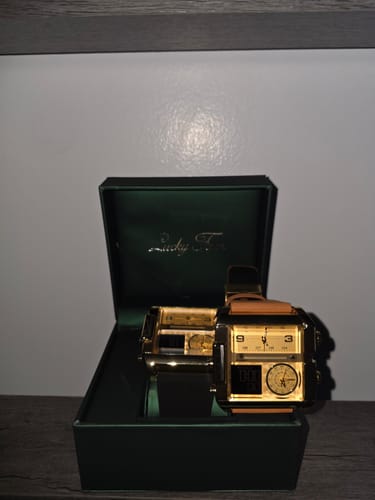 Reviewer's gold Lucky Fours Viceroy watch with a tan strap, displayed in its green box.