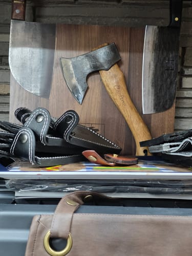 Reviewer's strong Walnut Magnetic Knives Holder holding two large cleavers and a hatchet.