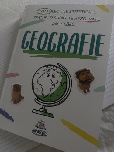 Customer's Carte Geografie Bacalaureat Bacademia book with globe illustration and cat stickers on the cover.