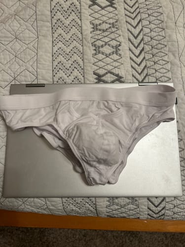 Customer's white Modal Briefs V-Fly resting on a closed laptop.