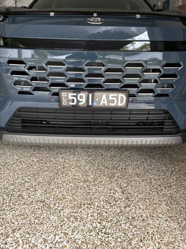 Customer's KINGPIN Slimline Number Plate Cover installed on a vehicle bumper, providing a sleek, clear finish.