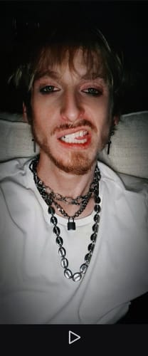 Customer's silver Chain of Addiction worn by a person, showing the metallic link chain and clasp detail.