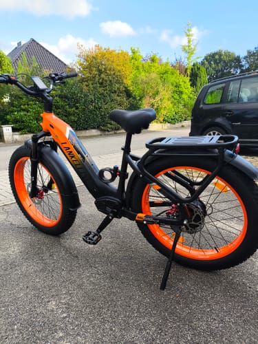 Customer's orange and black Lankeleisi MG600 Plus fat e-bike parked on a driveway outside