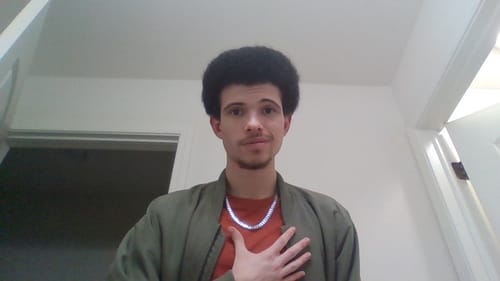 Customer's shiny Cuban Chain worn around the neck against a casual shirt.