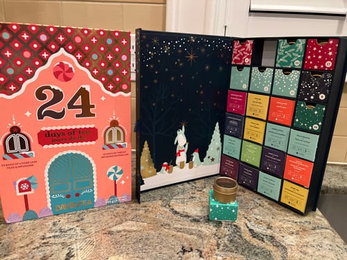 Customer's 24 Days of Tea Advent Calendar open on a counter, showing the colorful numbered boxes and internal artwork.