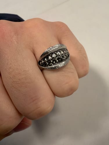 Customer's silver Catacomb Grillz Ring worn on a hand, showing the detailed skull-teeth design on the lips band.