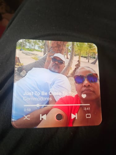 Customer's Personalized Music Fridge Magnet featuring a photo of a couple on a beach, overlaid with music player icons.