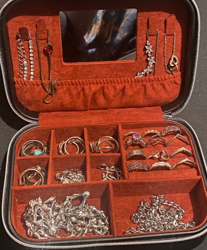 Customer's open DYT Travel Jewelry Case filled with many rings and silver chains.