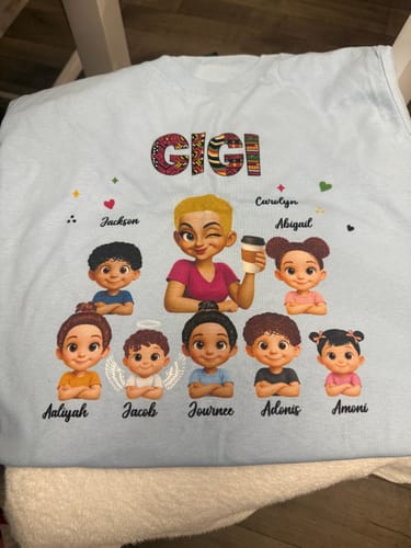Customer's light blue Tribal Pattern Grandma Grandkids Love shirt personalized with Gigi and character illustrations.