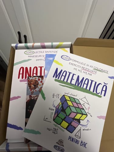 Customer's Carte Matematică Bacalaureat, the white textbook with a Rubik's cube illustration, inside an open box.