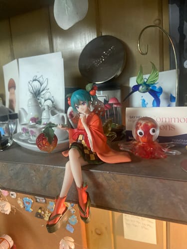 Customer's Hatsune Miku Sour Berry Fairy figure sitting on a shelf surrounded by various desk items.