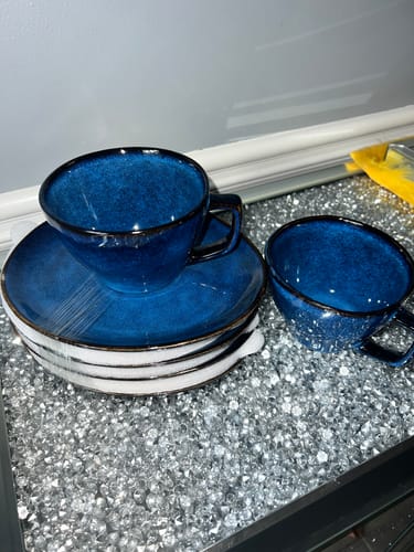 Customer's Ocean Blue Large Cup & Saucer Set, showing a stack of three saucers and two deep blue stoneware cups.