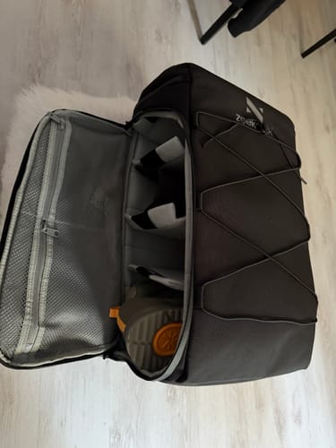 Customer's opened The Organizer 30L backpack showing the spacious main compartment with one removable divider inside.