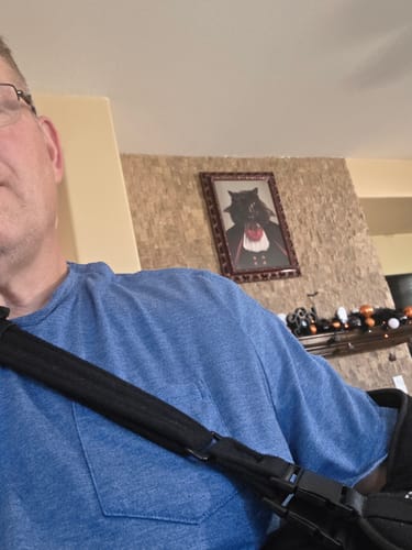 Reviewer in a post-operative sling wearing the blue Not Today Satan Uzi T-Shirt.