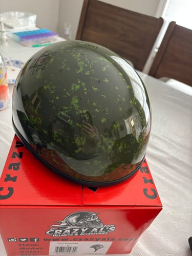 Customer's Green Forged SOA helmet with a glossy, green forged-carbon finish, sitting atop its product box.