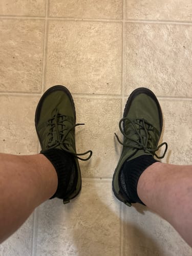 Reviewer showing the wide toe box of the olive green Forestep Ⅰ Barefoot Shoes while wearing them.