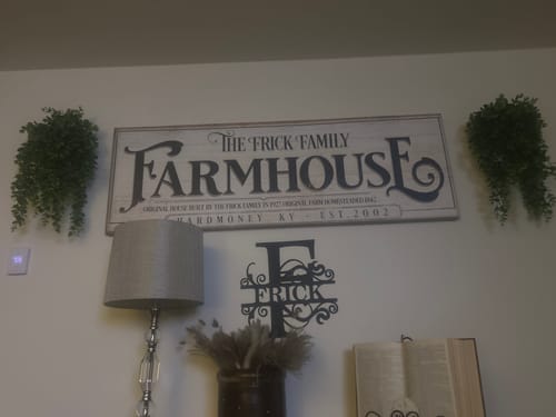 Customer's personalized Vintage Rust Farmhouse Sign, the centerpiece on their living room wall.