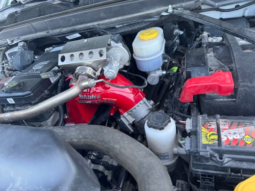 Customer's bright red Monster-Ram Intake Upgrade installed in a truck's engine bay.