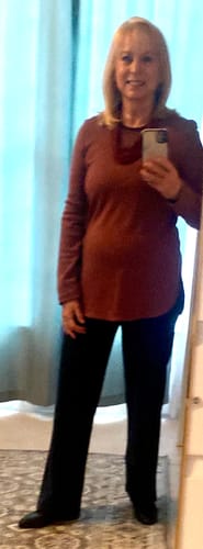 Reviewer showing the fit of the deep navy Ellie Wide Leg Pants, styled with boots.