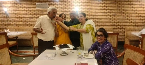 Reviewer smiling at a gathering while wearing the 22k Gold Plated Sui Dhaga Ravya Earring.