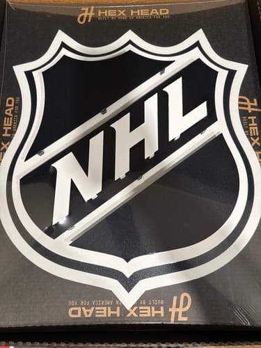 Customer's NHL Shield 3D metal wall art from Hex Head shown inside its original packaging.