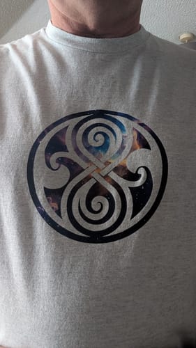 Close-up of a customer's grey unisex t-shirt showing the print quality of a custom logo.