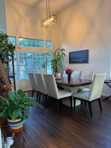 Customer's Goodness Of God Faith Sign II hanging on a high wall in a well-lit dining room.