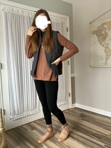 Reviewer wearing the black Piper Pocket Tall leggings, showing the full-length fit with a vest and boots.