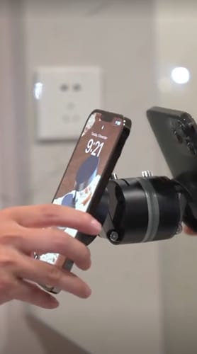 Customer attaching a phone to the powerful MagPro Magnetic Phone Holder mounted on a mirror.