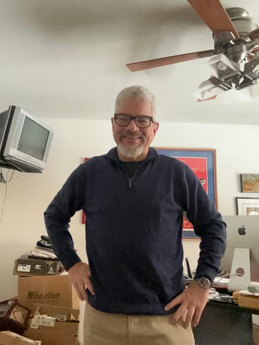 Reviewer showing the fit of the dark blue Enzo Quarter Zip pullover while standing with hands on hips in a room.