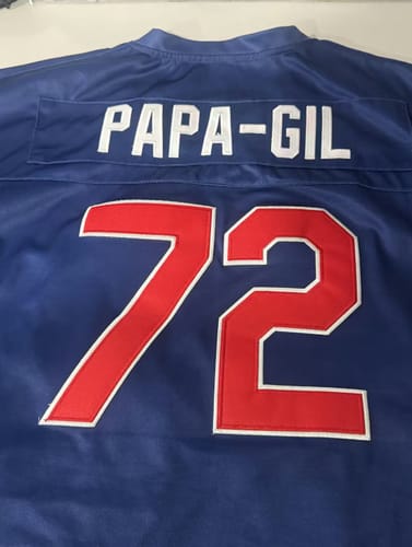 Customer's close-up of the back of a blue Puerto Rico Football Jersey showing the custom embroidered name 'PAPA-GIL' and number '72'.
