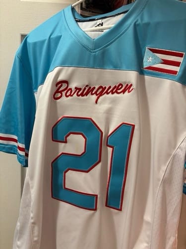 Close-up of a customer's Puerto Rico Heritage Football Jersey, showing the embroidered 'Borinquen' text and number 21.