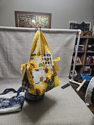 Customer's finished Box Bottom and Bows Tote made from yellow patchwork fabric with sunflower prints and side bows.